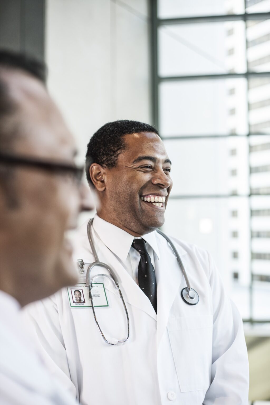 Black man doctor in lab coat with a stethescope.