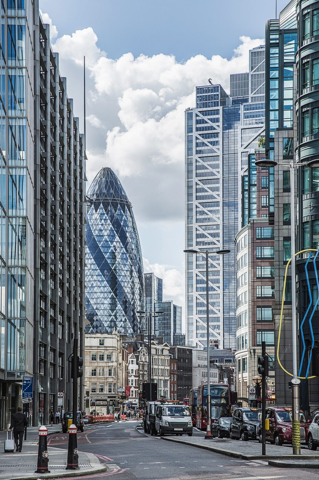 View of city street and Gherkin building, London, England, UK